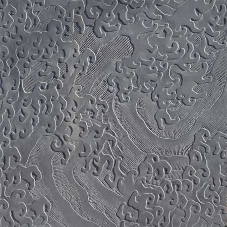 Stone carving of masculine waves